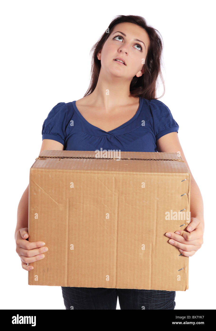 Exhausted young woman carrying a moving box. All isolated on white