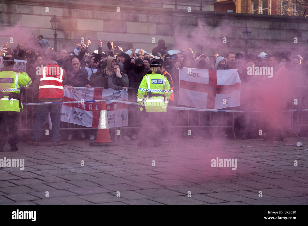 English Defence League EDL protesters set off smoke bombs as police