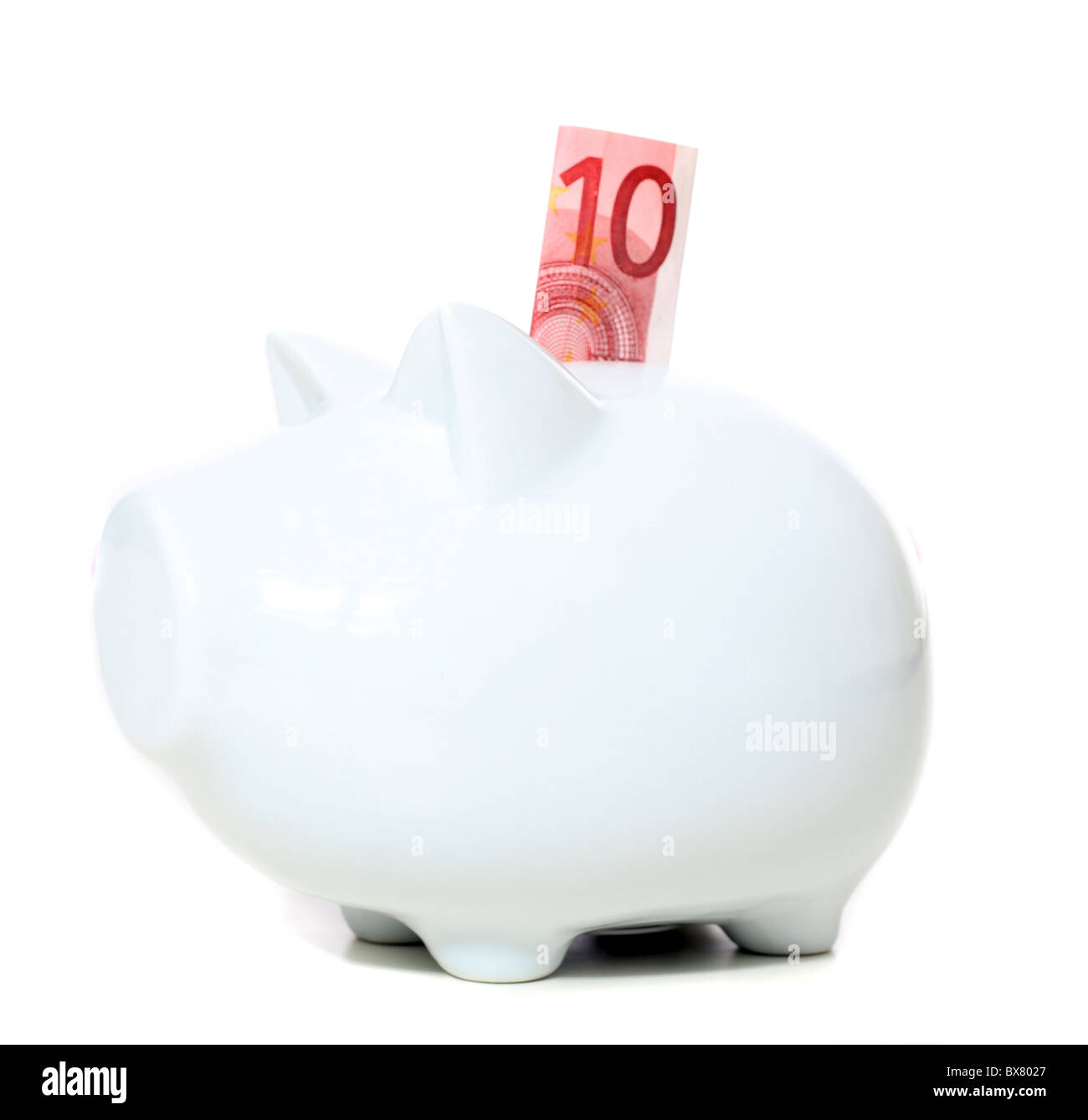 Piggy bank with 10 Euro note. All isolated on white background Stock Photo