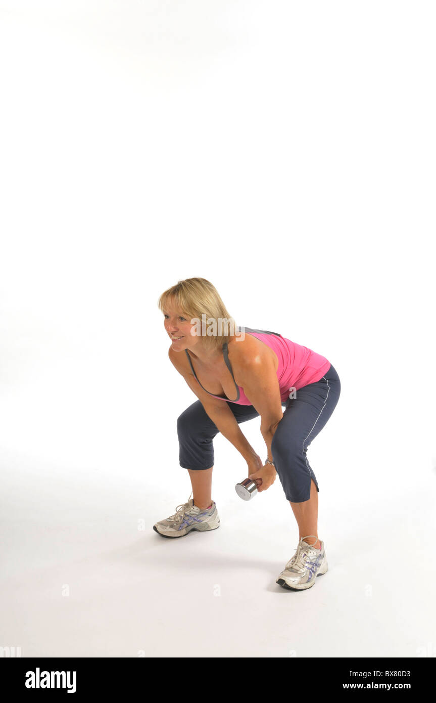 Overhead swinging  Dumb bell raise with squat Stock Photo