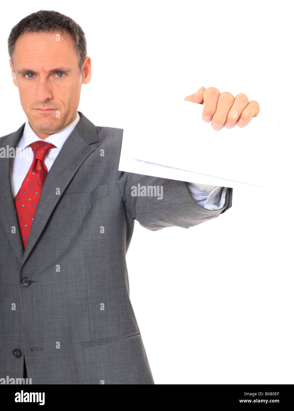 Serious businessman holding letter. Extra text space. All on white background. Stock Photo