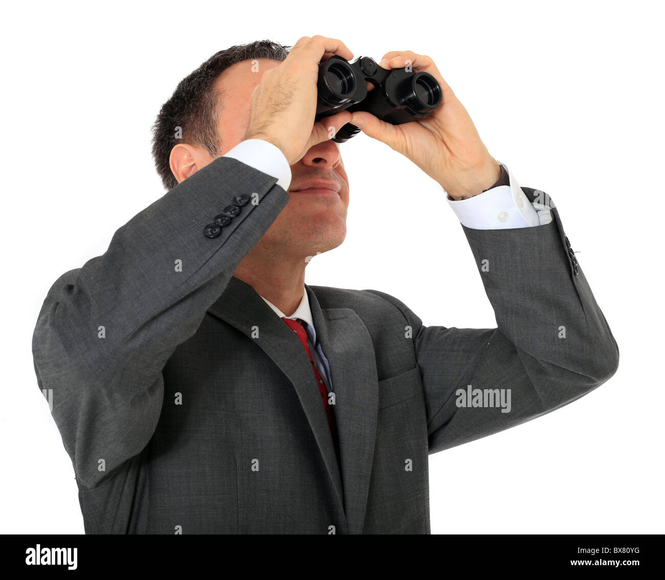 Attractive businessman using spyglass. All on white background. Stock Photo