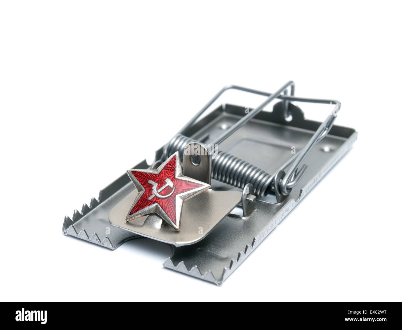 Red communist star on the mousetrap isolated on a white background. Stock Photo