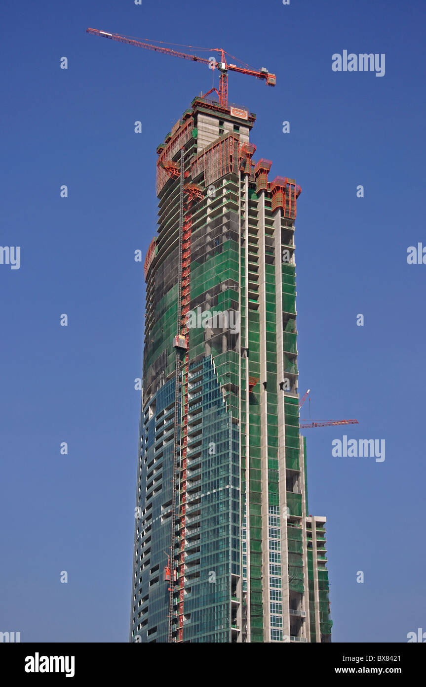 New skyscraper under construction across Chao Phraya River, Khlong San District, Bangkok, Thailand Stock Photo