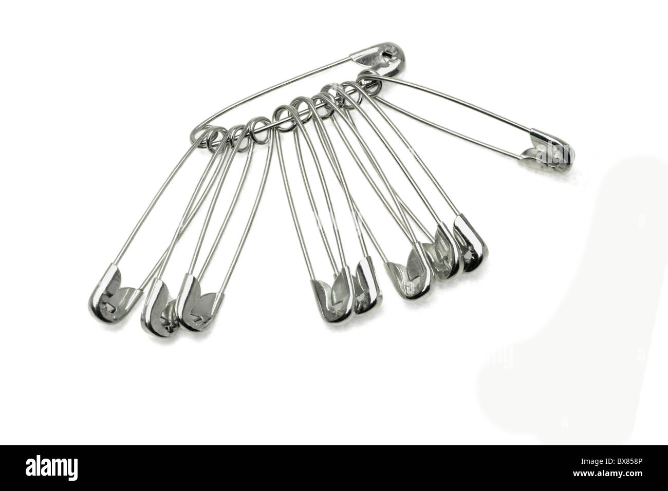 Safety pins locked together on white background Stock Photo