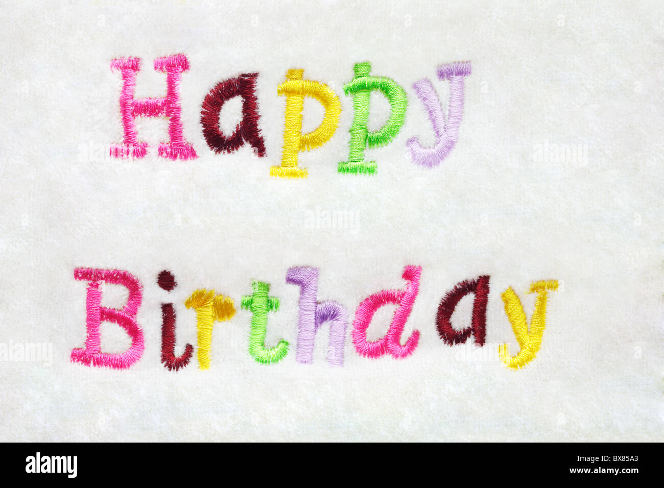 colorful Happy Birthday greeting embroidery on white Stock Photo