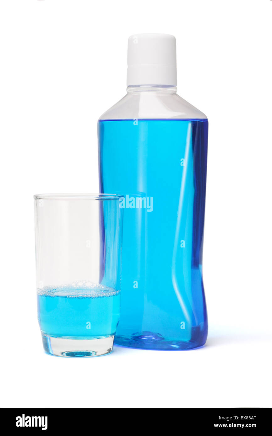 Plastic bottle and glass of mouthwash on white background Stock Photo