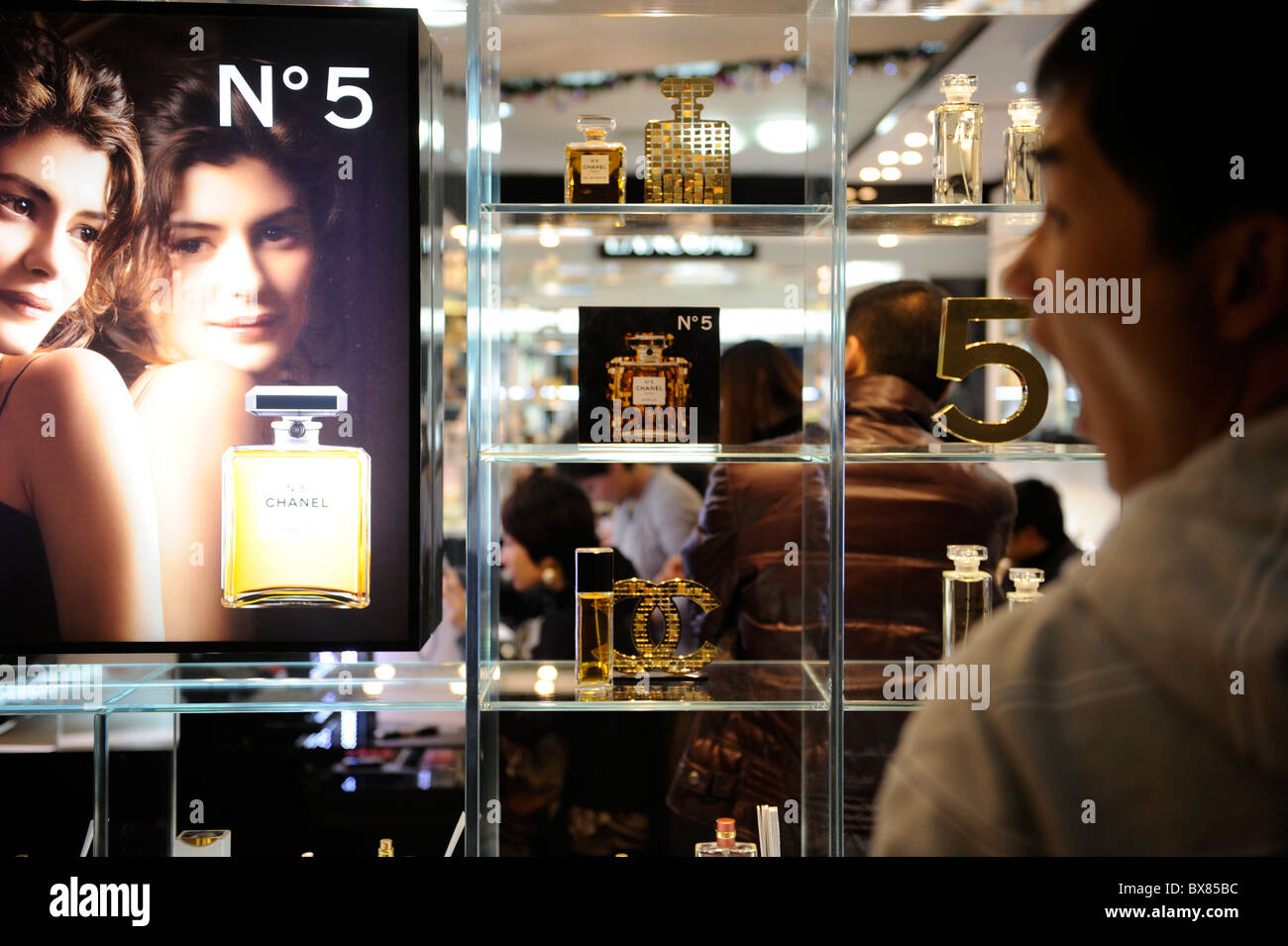 Chinese man looks at Chanel perfume in a shopping mall in Beijing, China. 12-Dec-2010 Stock Photo