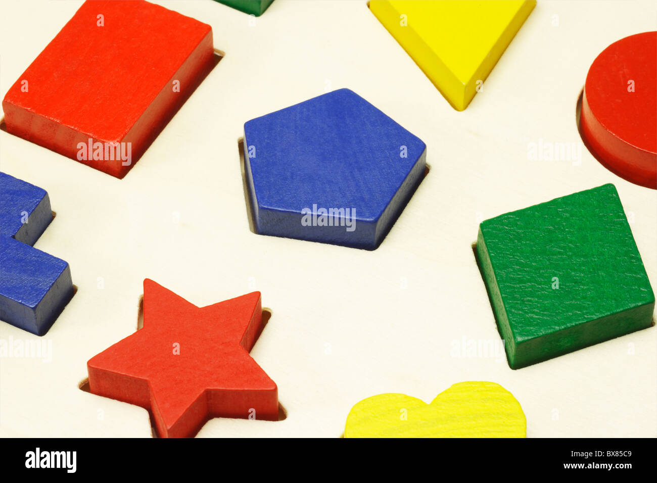 Assorted colored building blocks in correct shape holes Stock Photo