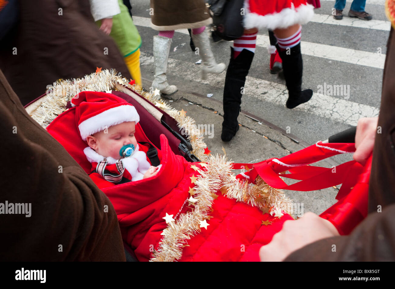 New York, NY - 11 December 2010 INfant in a Santa Suit during Santacon Stock Photo