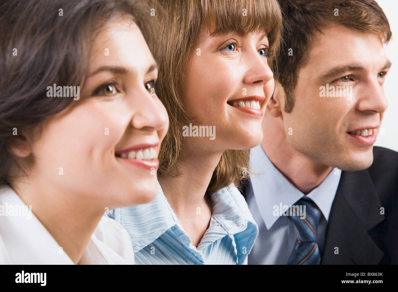 Portrait of three young smiling businesspeople Stock Photo - Alamy