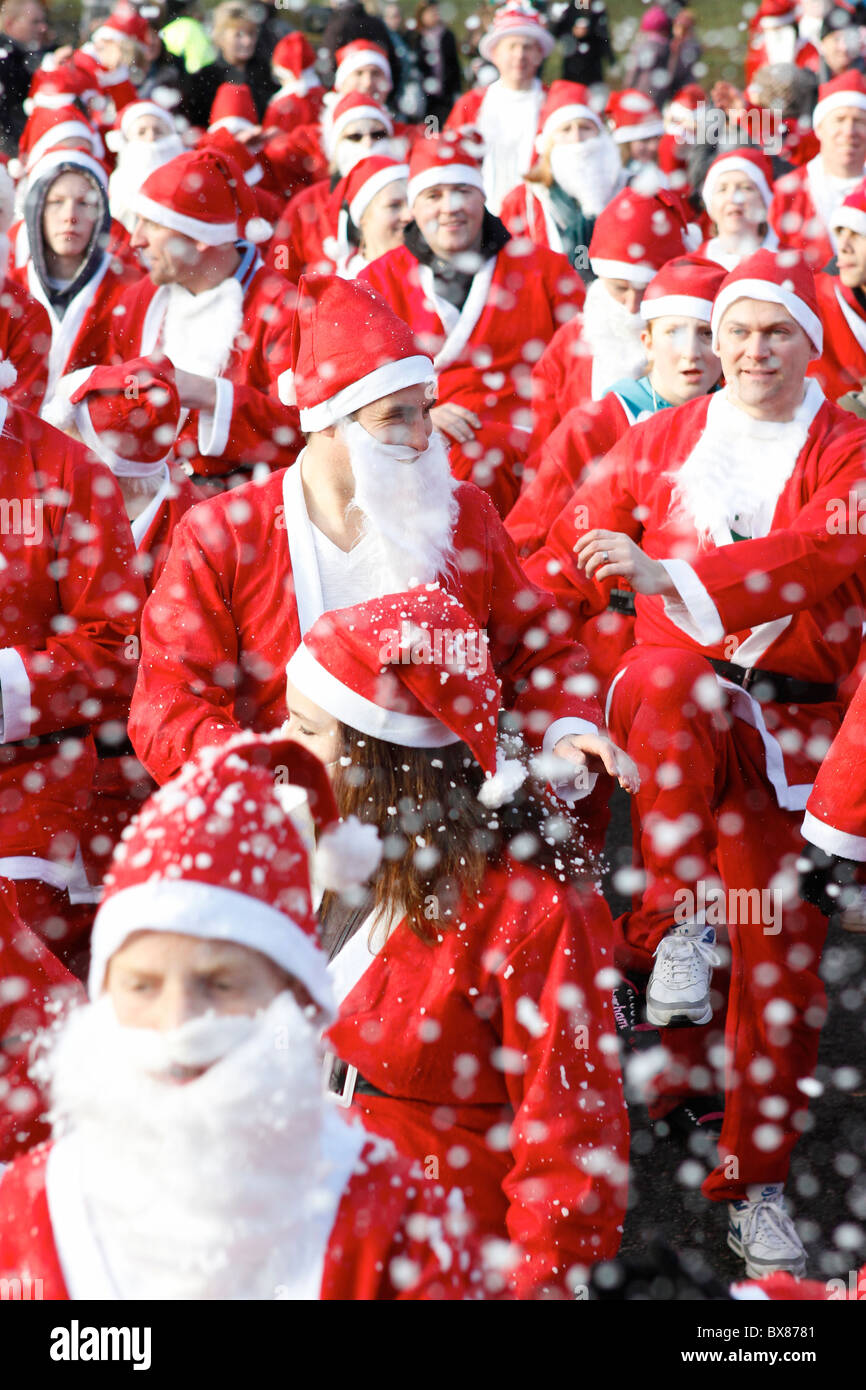 crowd of  santa clauses - charity santas at christmas Stock Photo