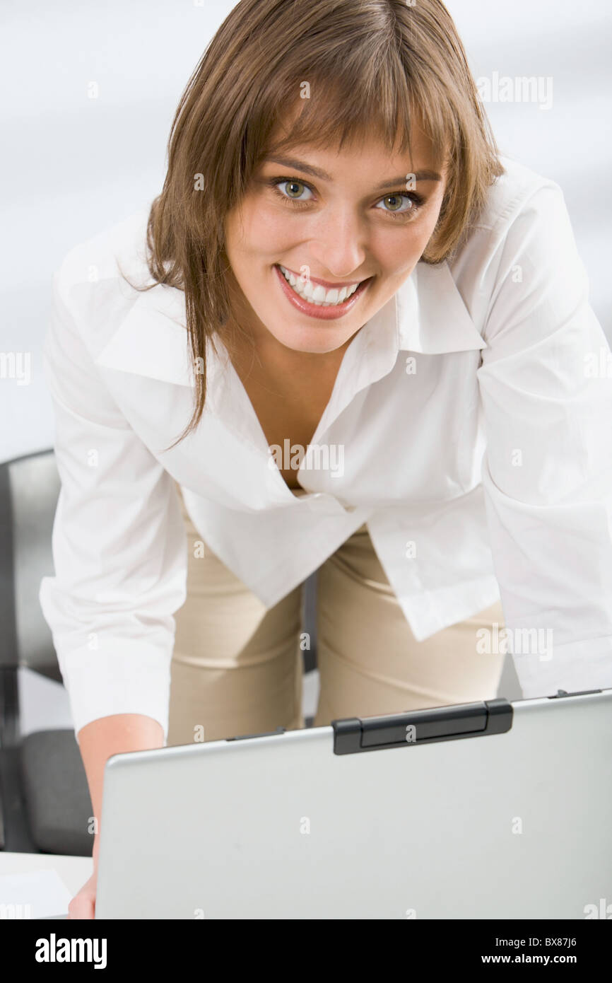 Portrait of successful young business woman smiling in the office Stock ...