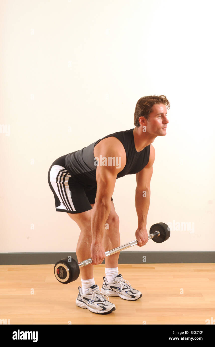 25-30 yr old male exercising in health club studio Stock Photo