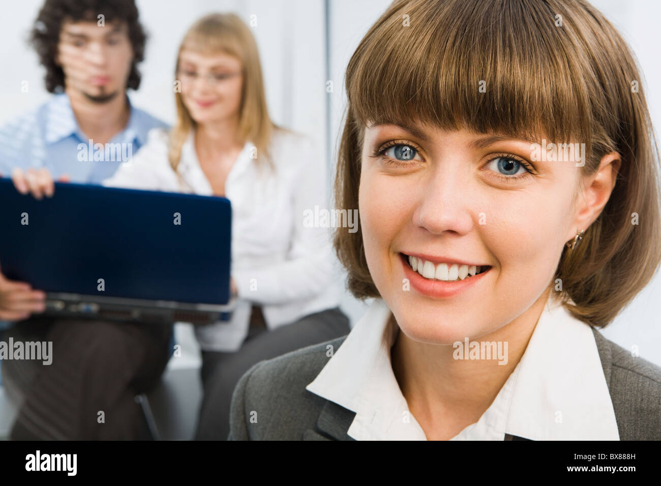 Portrait of successful young business woman smiling on the background ...
