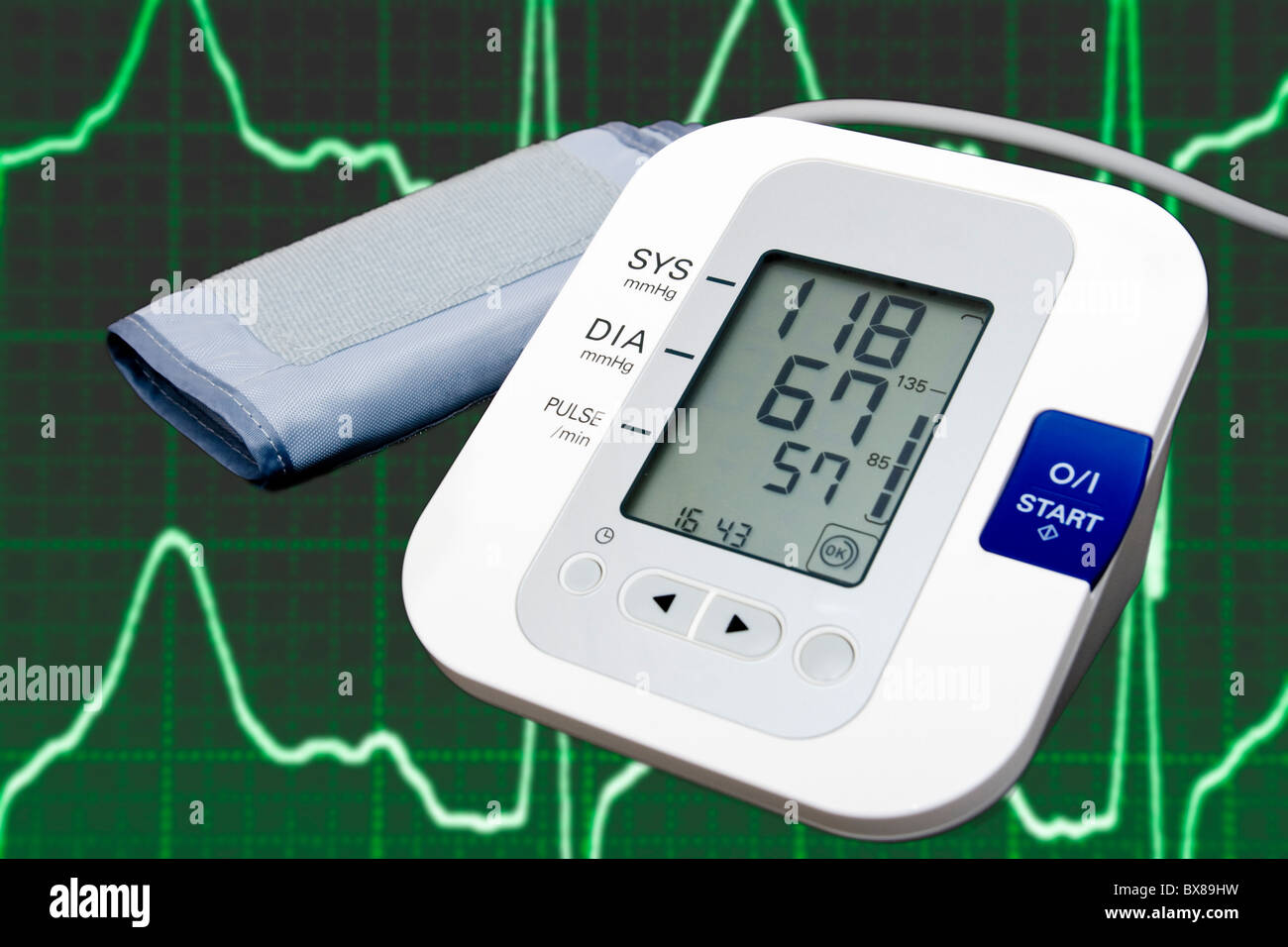 Digital blood pressure monitor with cardiogram in the background Stock Photo