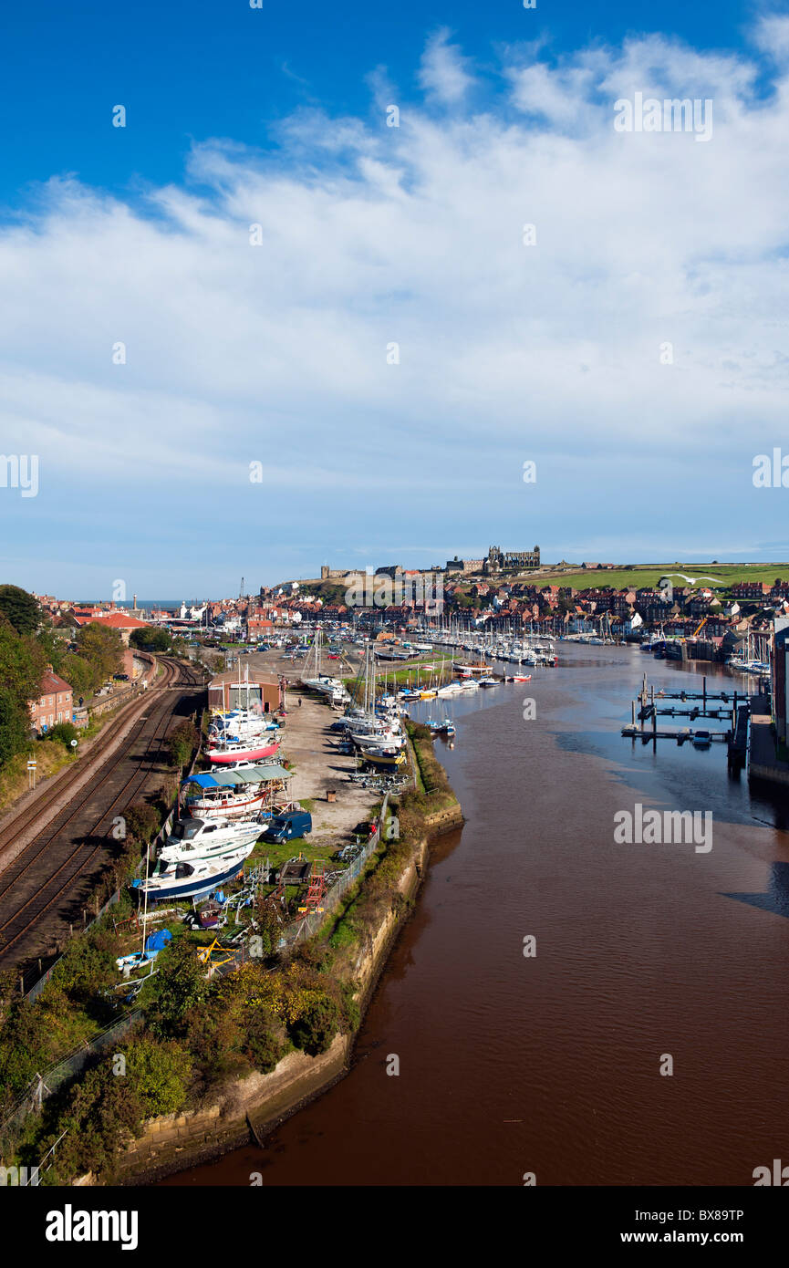 The River Esk Estuary at Whitby, North Yorkshire on a sunny day. There are many sailing and motor boats berthed on the river Esk here. It is sunny. Stock Photo