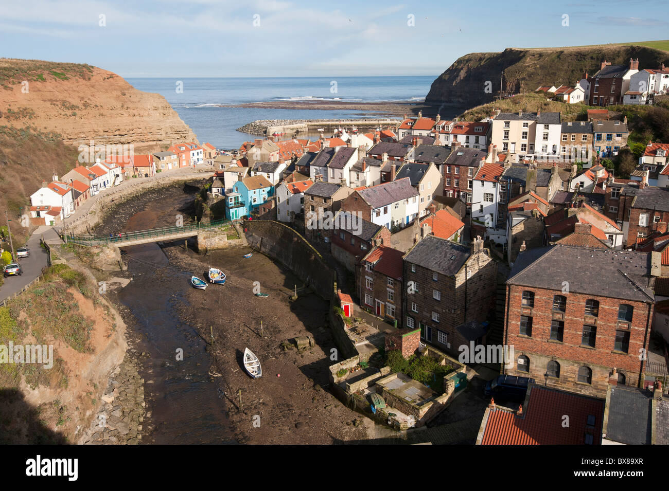 Staithes, on the East coast of Yorkshire, England, is a great place to visit on a sunny day. The River Esk flows through the town to the sea. Stock Photo