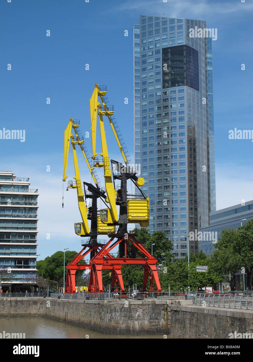 Old restored cranes and modern buildings with glass facades, Puerto Madero, Buenos Aires, Argentina Stock Photo