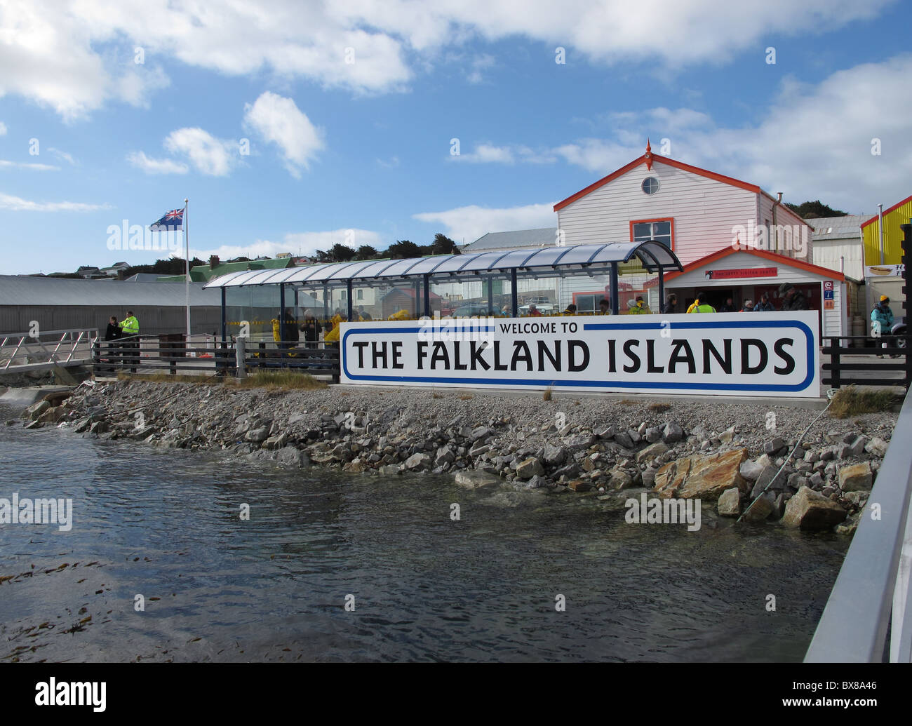 Pier with sign and flag 'The Falkland Islands', Port Stanley Stock Photo