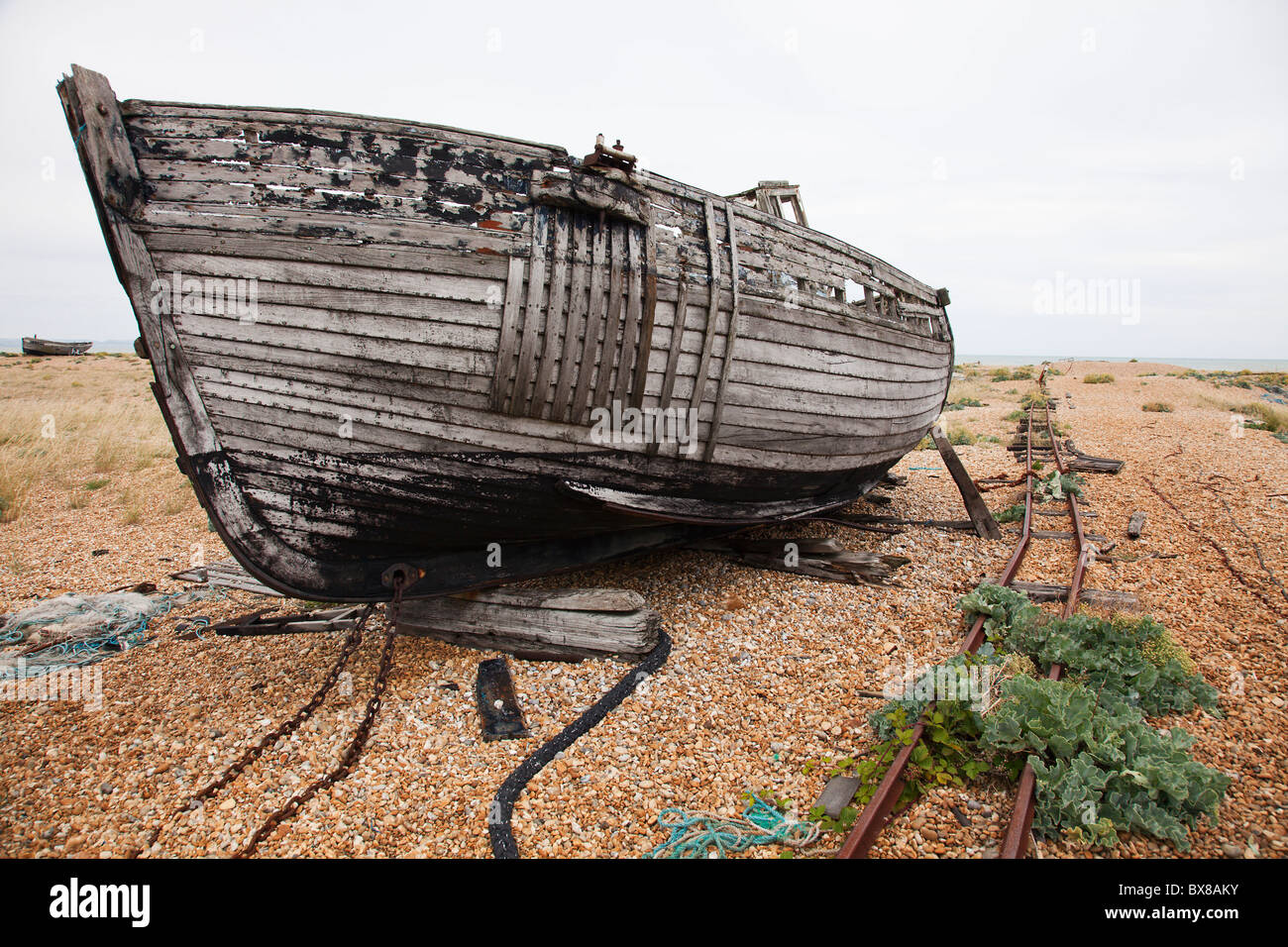Abandoned fishing boat on the shingle beach at Dungeness, Kent, UK ...