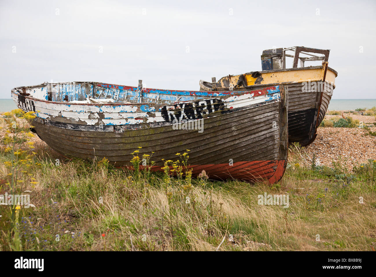 Abandoned fishing boats on the shingle beach at Dungeness, Kent, UK ...