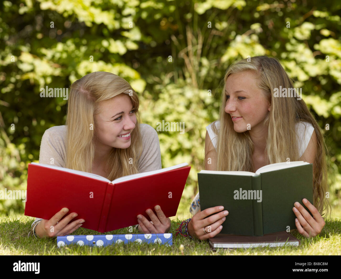 Two girls reading in the park Stock Photo