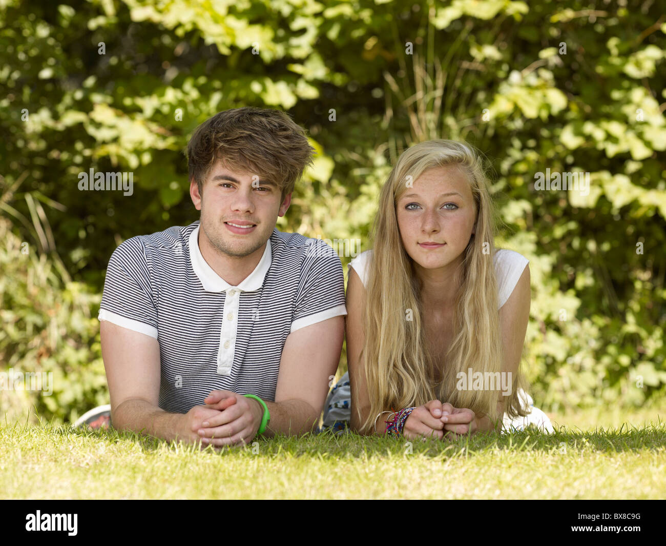 Two friends lying in the park Stock Photo