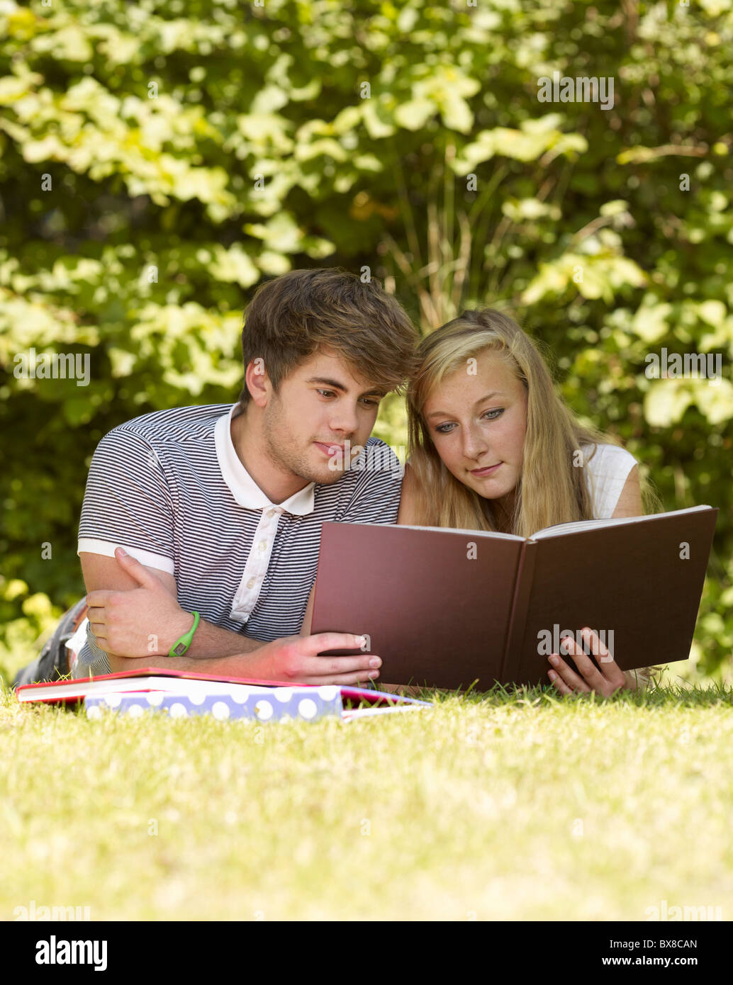 Two friends reading a book Stock Photo