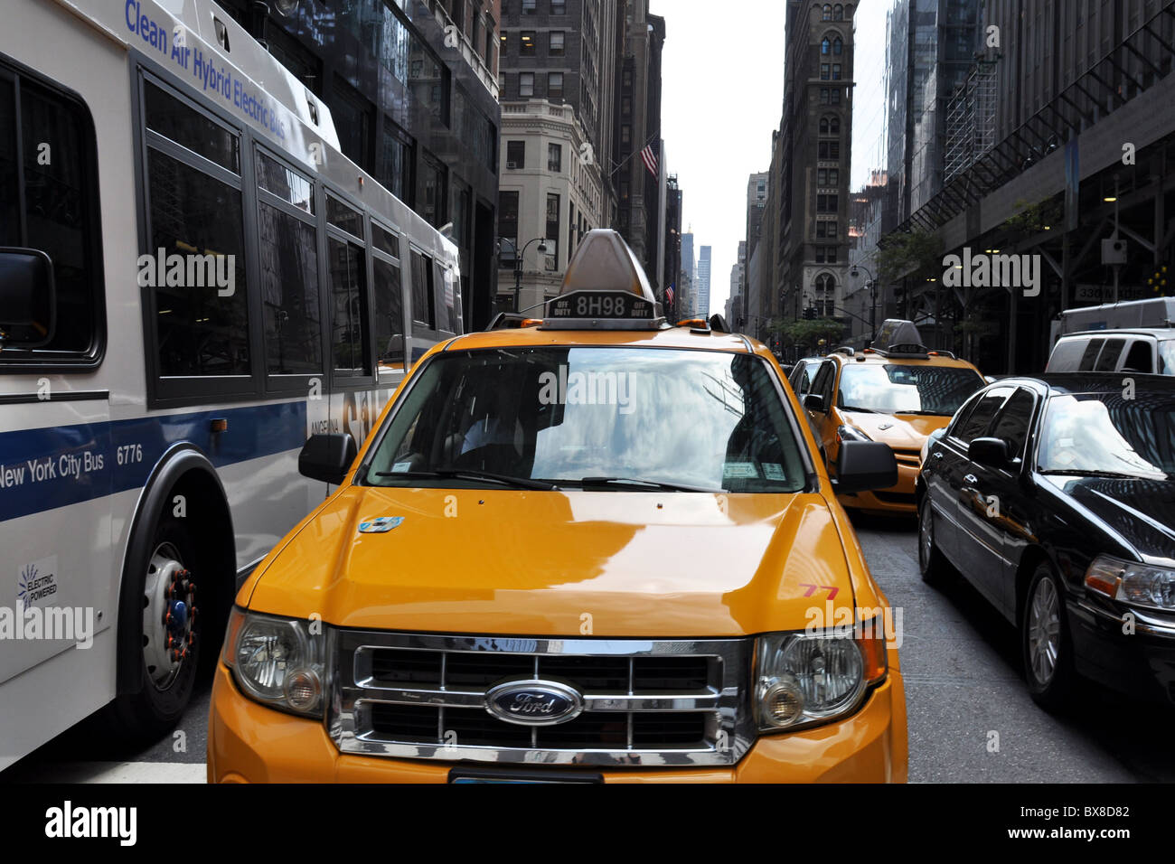 New York Cabs congest the Manhattan Streets alongside the Hybrid Electric buses Stock Photo