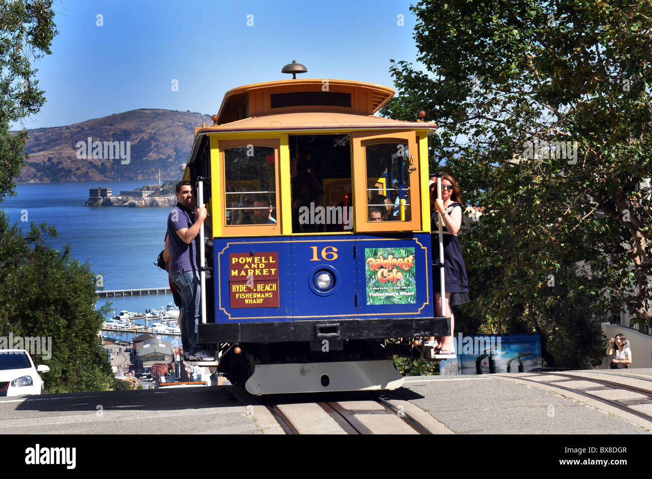 Tourists ride the San Francisco Cable Car, California USA Stock Photo