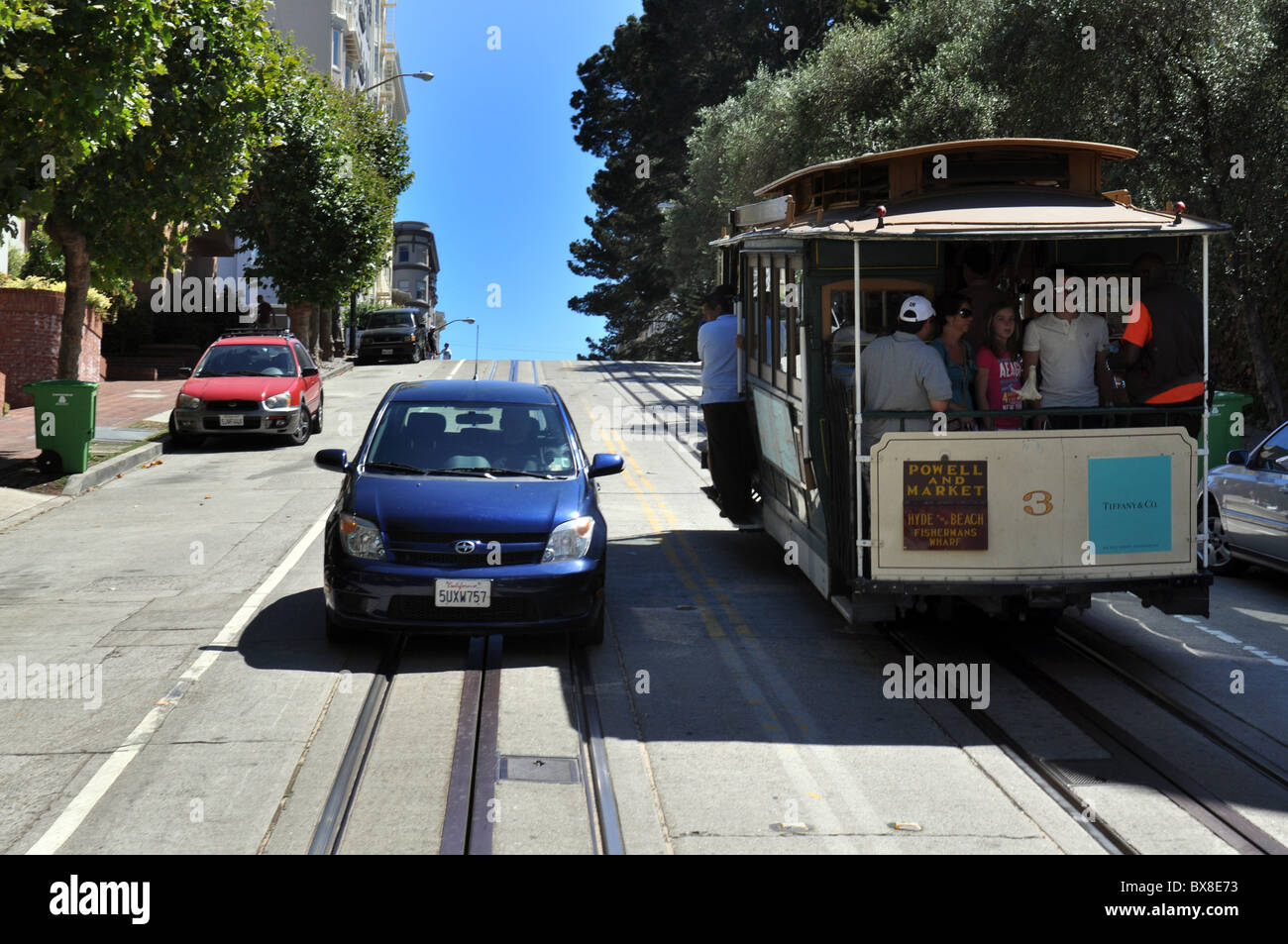 Tourists ride the San Francisco Cable Car, California USA Stock Photo
