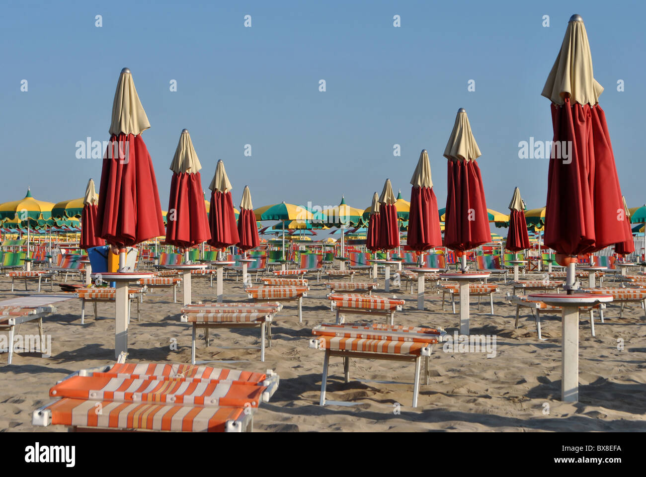 umbrellas on the beach with deck chairs for sun protection and ...