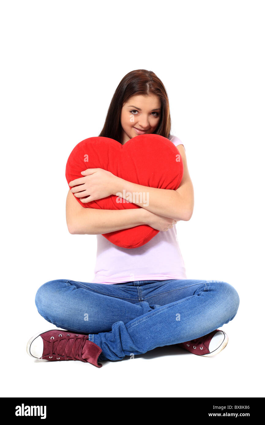 https://c8.alamy.com/comp/BX8K86/attractive-teenage-girl-hugging-red-heart-shaped-pillow-all-on-white-BX8K86.jpg