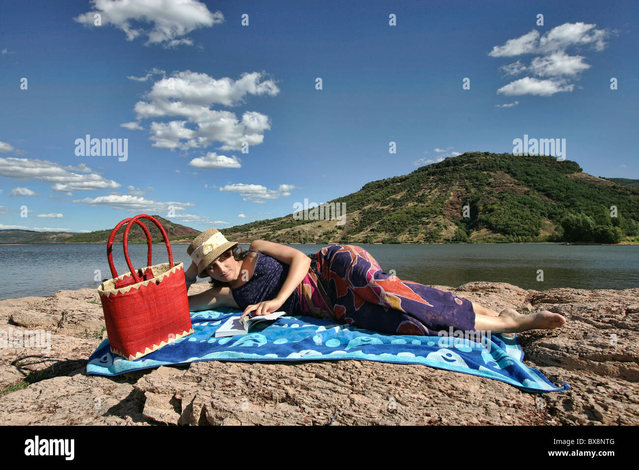 A pretty young girl relaxing by the water in summer Stock Photo - Alamy