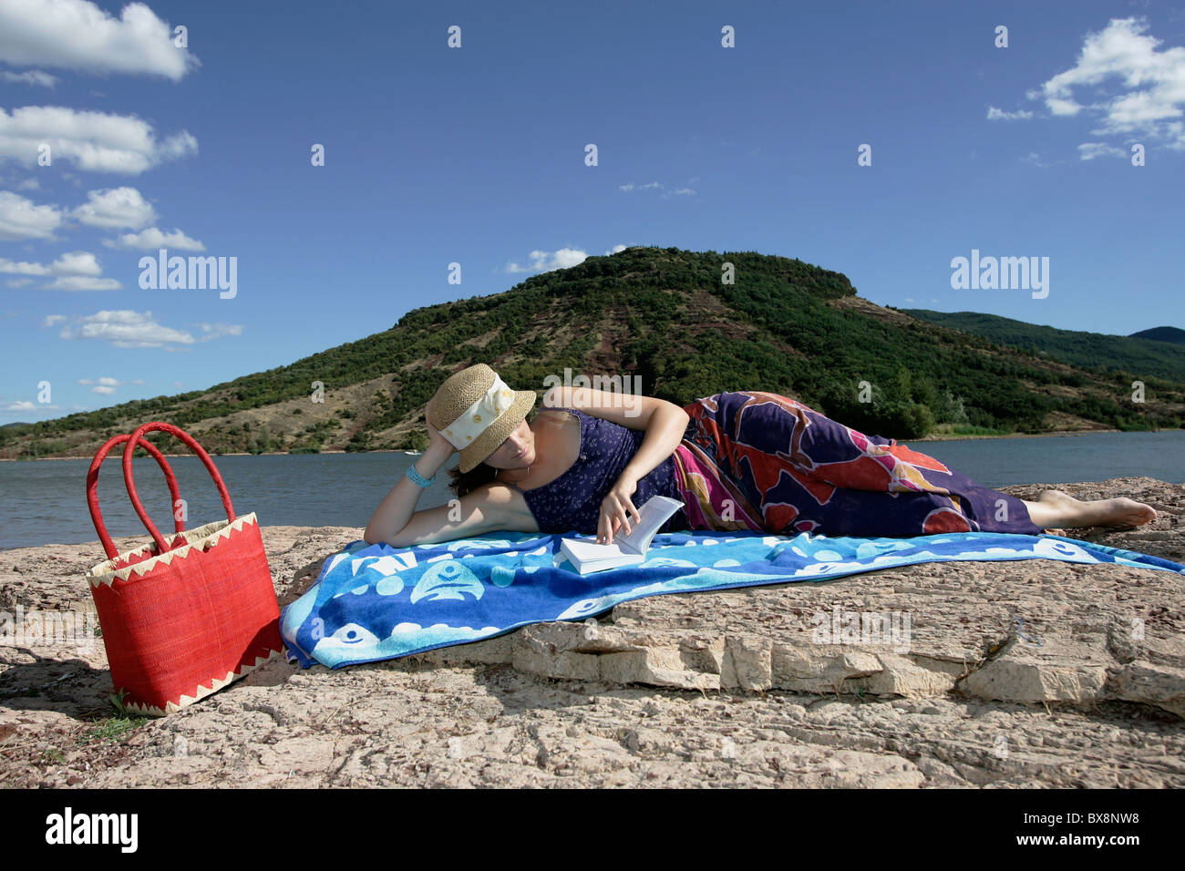 A pretty young girl relaxing by the water in summer Stock Photo - Alamy
