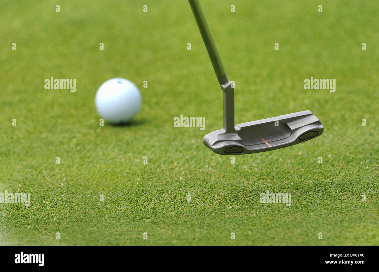 Close up of a putter and a golf ball Stock Photo