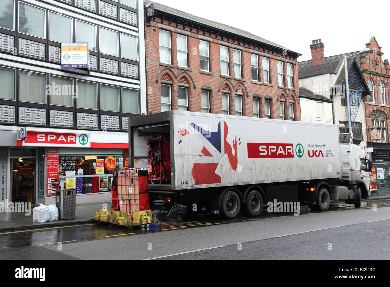 A truck delivering to Spar convenience store in a U. K. city Stock
