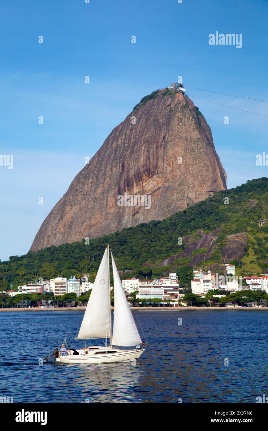 Morro da Urca and Pao de Acucar (Sugarloaf Mountain) with a sailboat, Rio de Janeiro, Brazil Stock Photo
