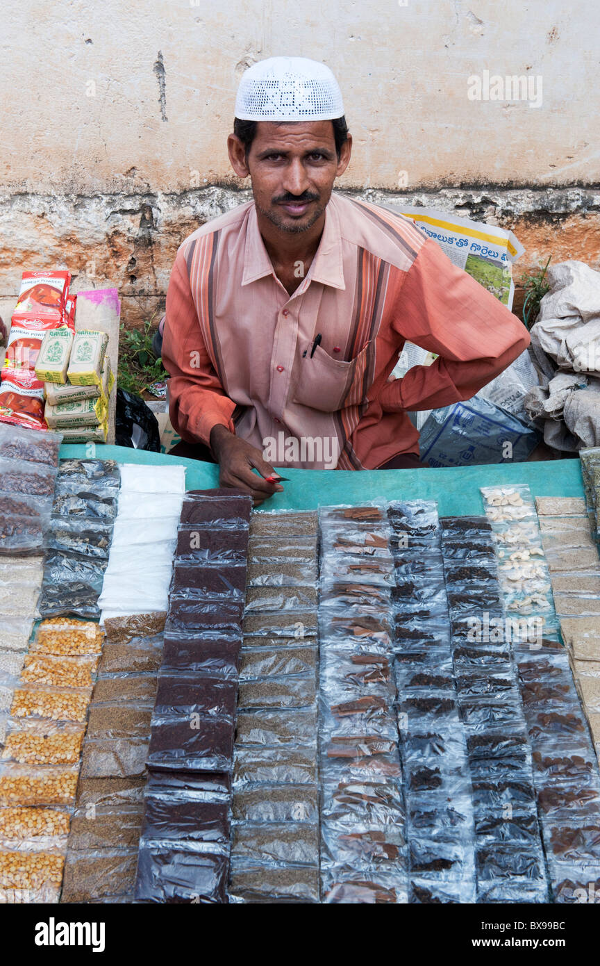 Muslim man selling spices in packets at an indian market, Andhra Pradesh. India Stock Photo