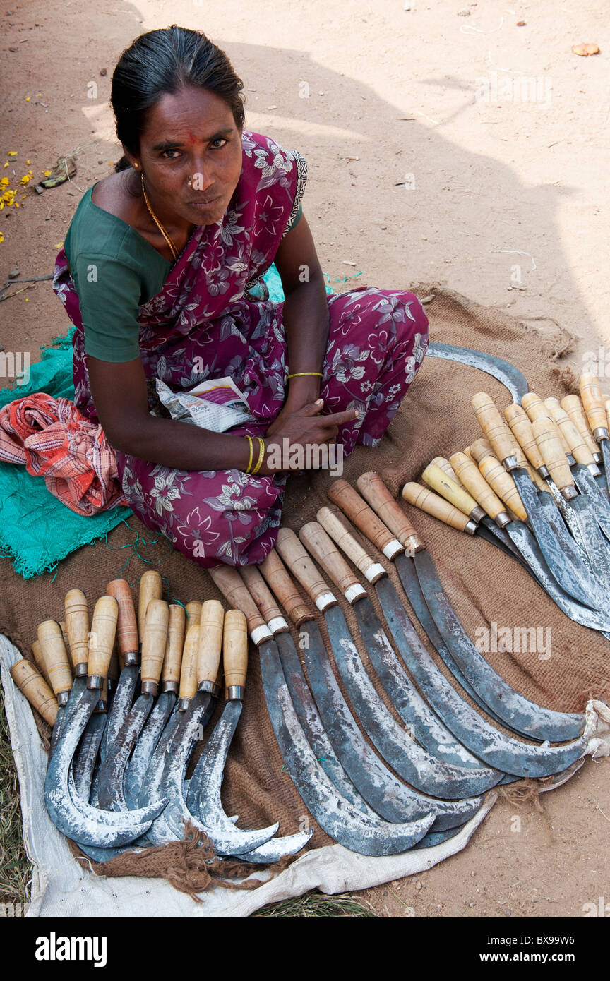 Indian woman selling billhooks (Hand Scythe) at an indian market. Andhra Pradesh, India Stock Photo