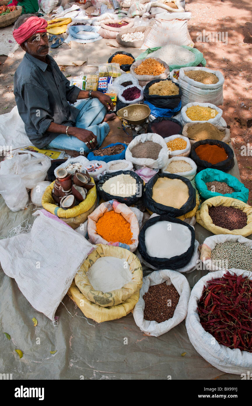 Indian man selling spices and dried produce from sacks at an Indian market. Andhra Pradesh, India Stock Photo