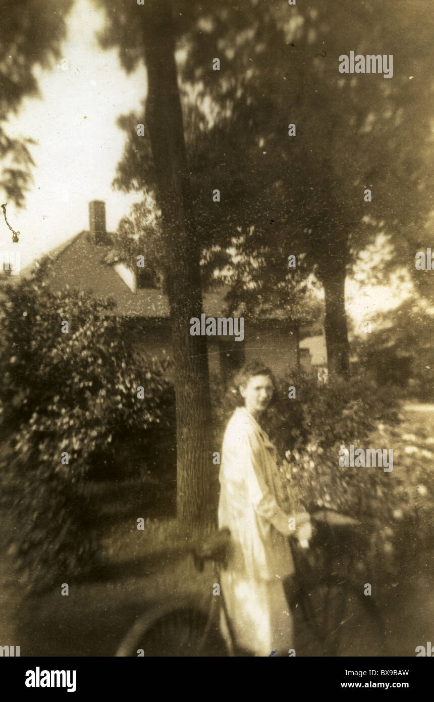 Woman with bicycle 1920s one person only outdoors dreamy nostalgia Americana black and white Stock Photo