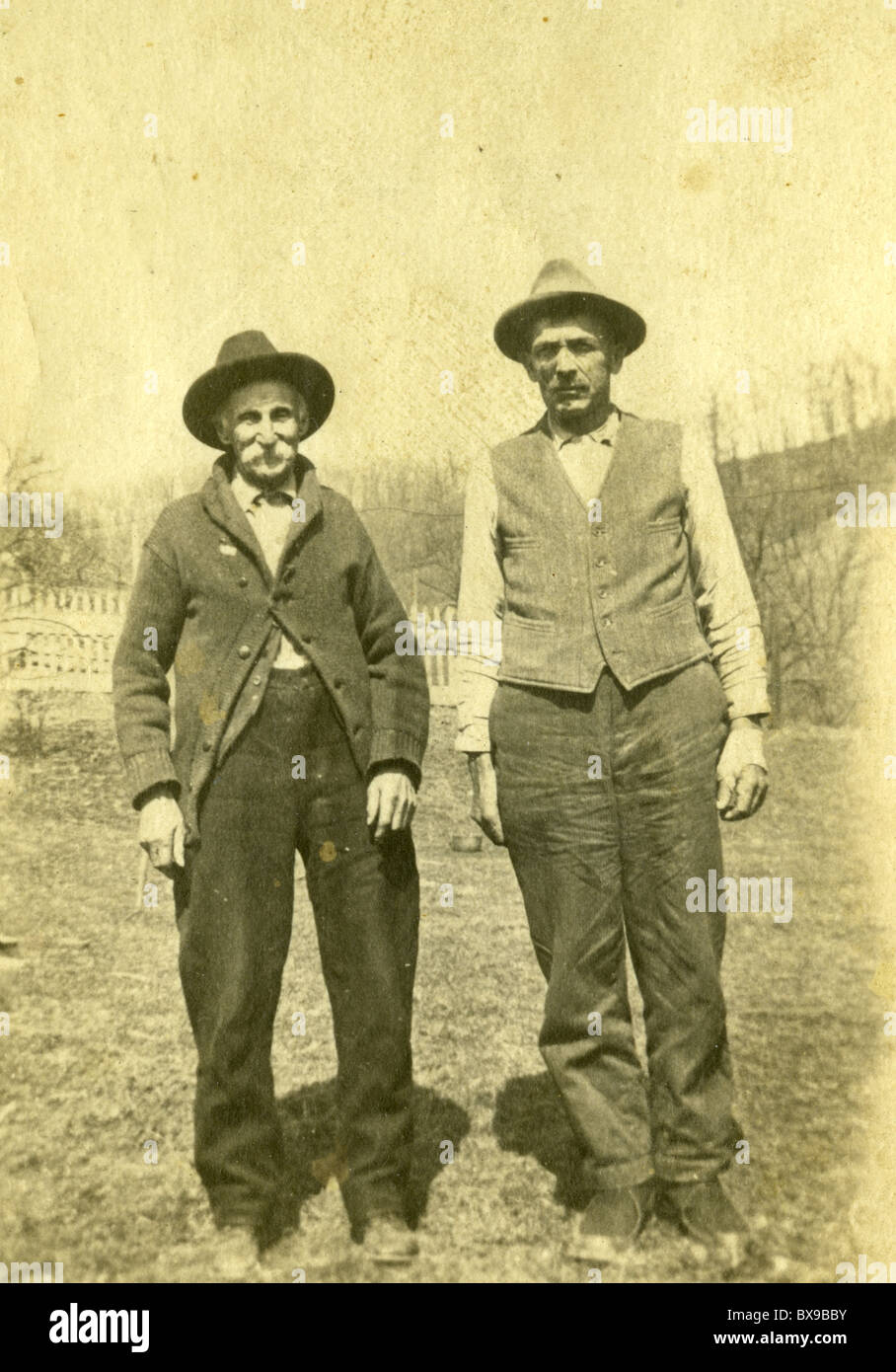 Father and son on the farm in rural america during the 1920s 1930s Americana black and white Stock Photo