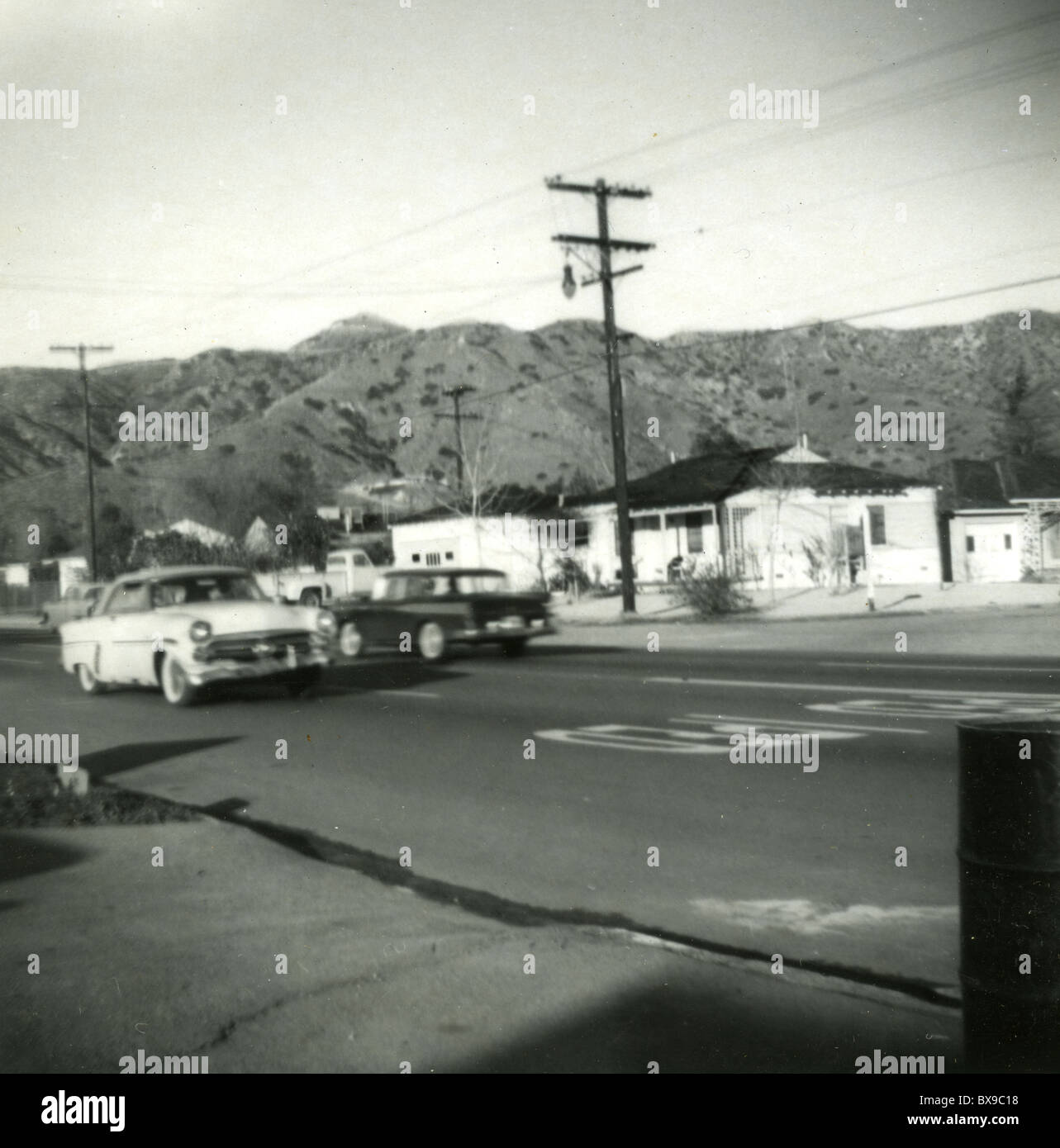 Two American cars passing on Southern California 1950s mountains street Americana black and white Stock Photo