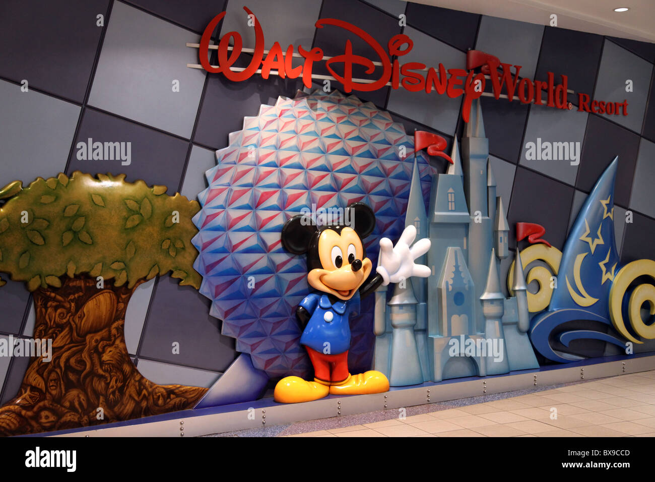 Mickey Mouse Waves I -- Walt Disney Logo, Orlando International Airport, Epcot, Castle, Relief Sculpture Greets Visitors at MCO. Stock Photo
