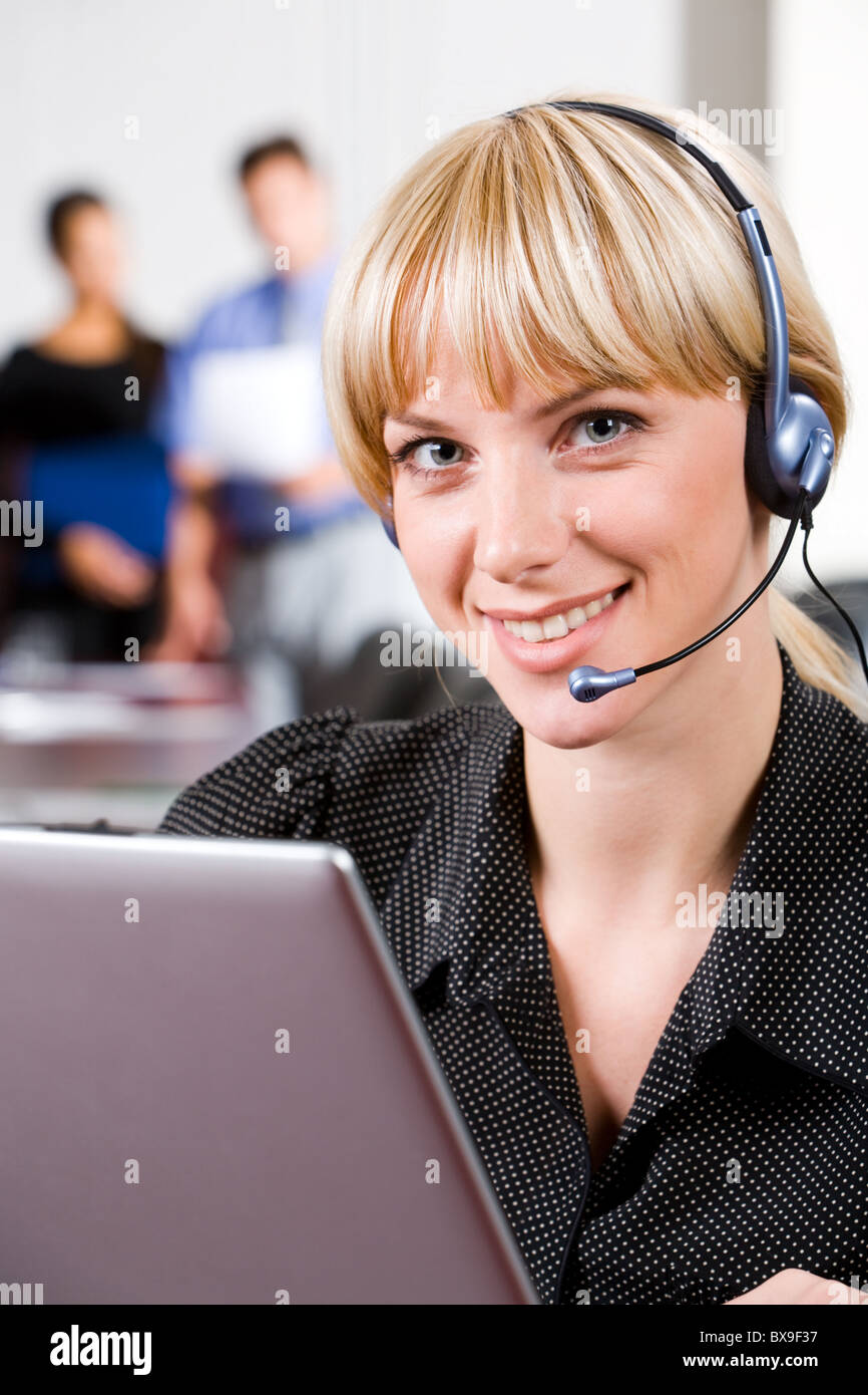 Portrait of friendly smiling telephone operator with headset Stock