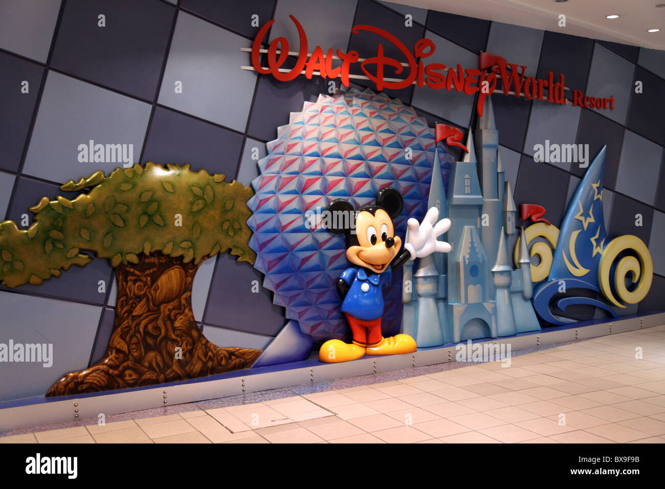Mickey Mouse Waves I -- Walt Disney Logo, Orlando International Airport, Epcot, Castle, Relief Sculpture Greets Visitors at MCO. Stock Photo
