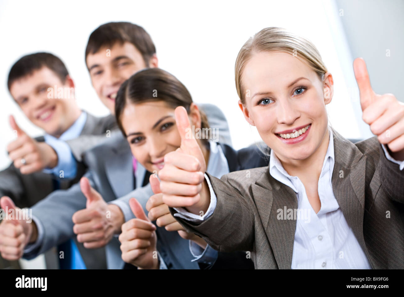 Portrait of business people giving the thumbs-up sign Stock Photo - Alamy