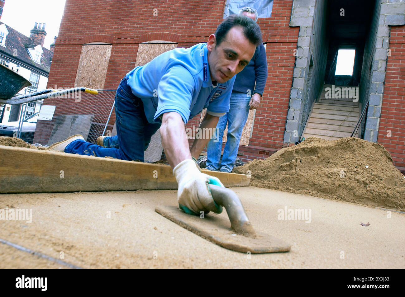 Laying sand for the foundation of a driveway England UK. Stock Photo